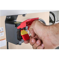 Showing a human hand pulling the power switch to turn on the Grizzly hybrid table saw